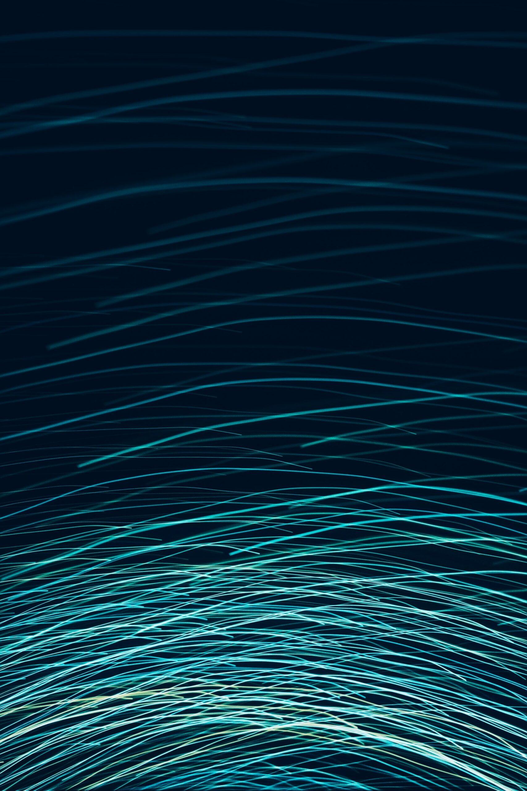 Abstract blue and teal light streaks on a dark background